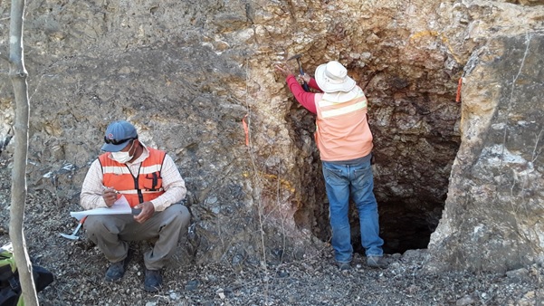 Photo 2. Geologists sampling along mineralized corridors that include historic adits and shafts.